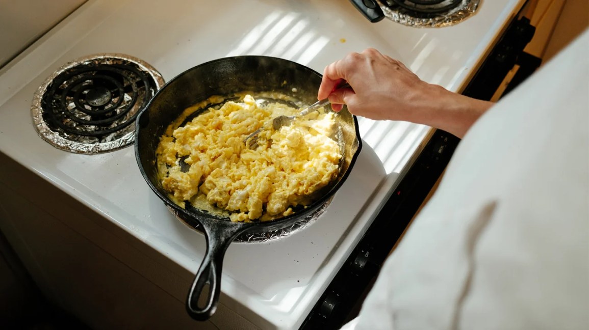 scrambling eggs in cast-iron pan